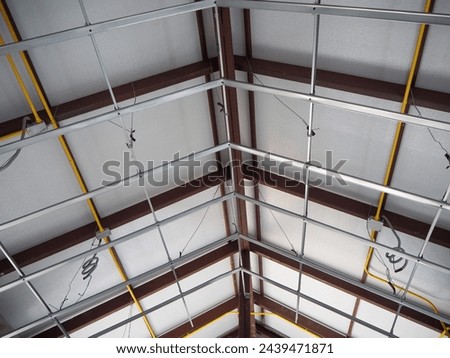 Aluminum ceiling structure for gable roof inside of a house at the construction site.    