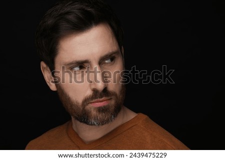 Evil eye. Man with scary eyes on black background, closeup and space for text