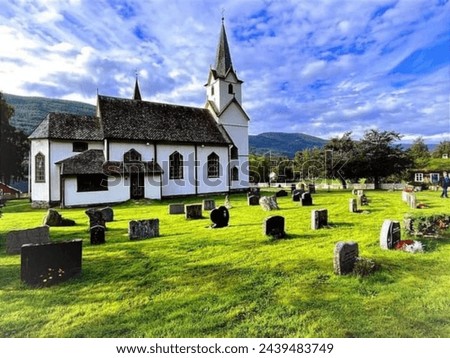 A serene sanctuary nestled in the heart of nature, this picturesque church stands tall amidst a tranquil grassy meadow.