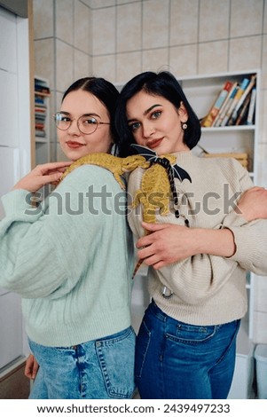 Sisters and Their Bearded Dragon: A Family Portrait