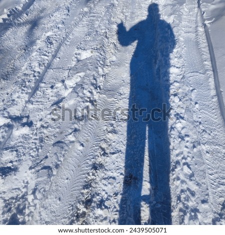 The shadow of the photographer in the winter season.