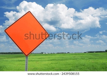 Empty orange road sign with abstract product background.
