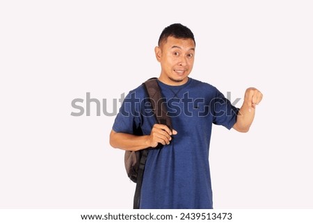 Asian mature man showing happy expression while pointing down wearing bag