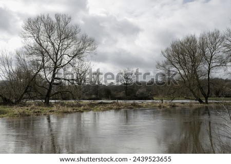 view of the River Avon at Salisbury Wiltshire England after it has burst its banks and flooded fields behind