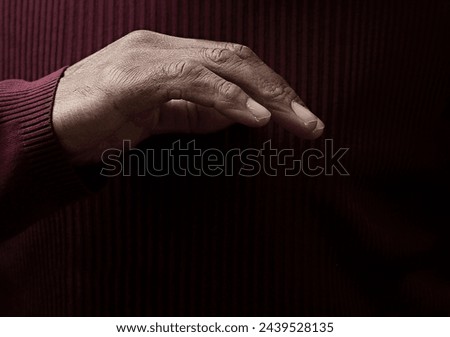 man praying to god with hands together on grey black background with people stock image stock photo