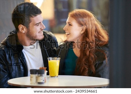 Couple, smile and eye contact in restaurant with love, romance and affection on anniversary date. Romantic, man and woman in cafe bonding with juice, beverage and laughter in relationship for dating Royalty-Free Stock Photo #2439534661