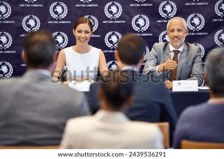 Politician man, woman and press conference at convention with journalist in audience for question at desk. People, news and press release story for public relations, seminar and panel for election Royalty-Free Stock Photo #2439536291