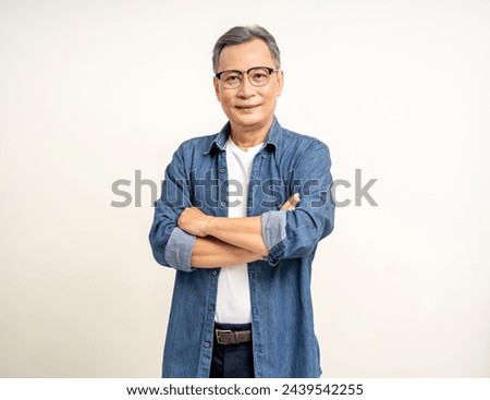 Handsome asian mature old man standing arm crossed on isolated white background. Happy Portrait of cheerful smiling senior asian man looking at camera. Mature People and lifestyle Royalty-Free Stock Photo #2439542255