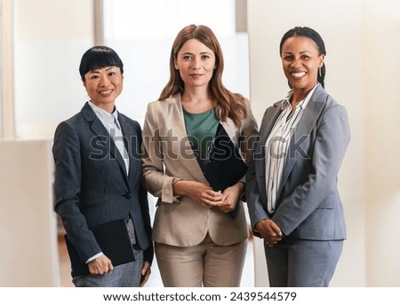 Portrait of a diverse multi-ethnic corporate team of businesswomen standing In an office corridor Royalty-Free Stock Photo #2439544579