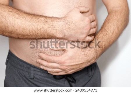 The man has a stomach ache. problems with the stomach, intestines