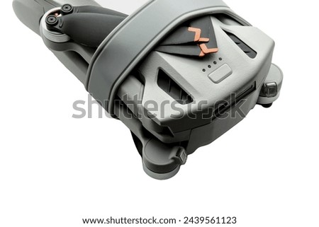 drone folded up (small recreational aircraft quad copter that shoots 4k video) isolated on white background (close up, macro, cut out) Royalty-Free Stock Photo #2439561123
