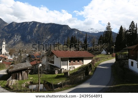 A picture from Kiefersfelden of the mountain overlooking Austria and also of the old cemetery in the German city bordering Austria.