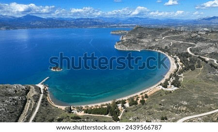 Aerial drone photo of paradise scenic round sandy beach of Karathonas next to historic city of Nafplio, Argolida, Greece