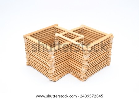 children's craft Arranged wooden ice cream sticks stuck with glue isolated on white , concept of DIY and kid's creativity and hobby