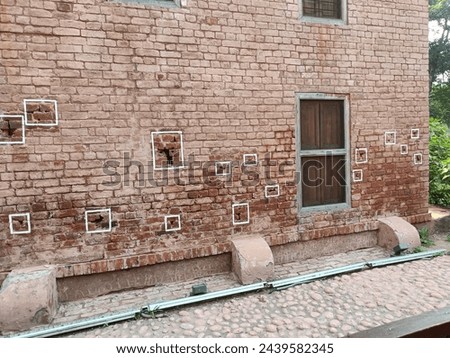 Discover the poignant history of Jallianwala Bagh with this image of the bullet-scarred wall. Each mark tells a story of sacrifice and resilience, a testament to India's struggle for independence Royalty-Free Stock Photo #2439582345