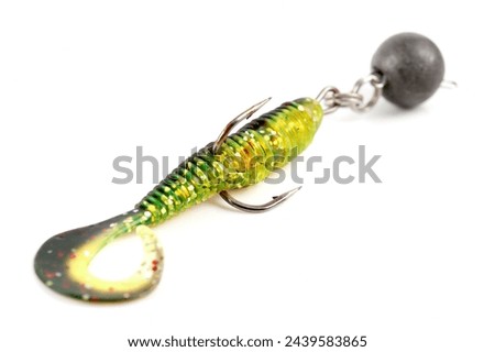 Soft fishing bait, moss green plastic grub, with double hook and lead sinker, isolated on white background Royalty-Free Stock Photo #2439583865