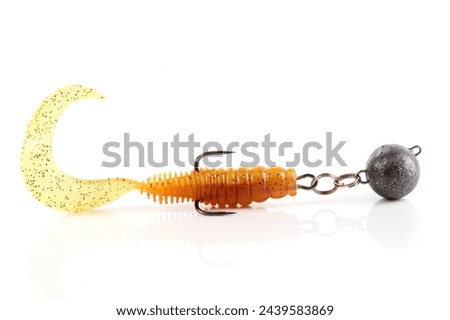 Soft fishing bait, silicone grub, with double hook and lead sinker, isolated on white background Royalty-Free Stock Photo #2439583869