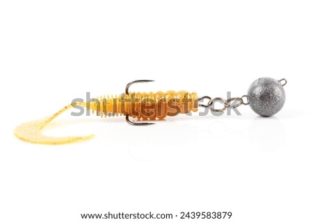 Soft fishing bait, silicone grub, with double hook and lead sinker, isolated on white background Royalty-Free Stock Photo #2439583879