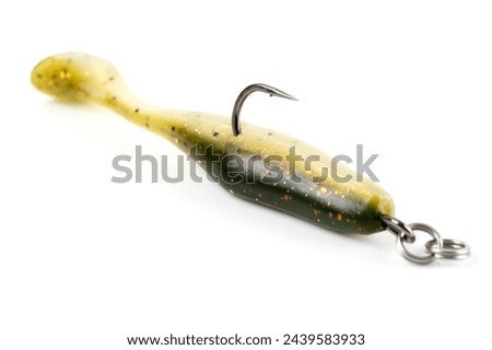 Orange fishing lure, plastic shad fish, with double hook, isolated on white background Royalty-Free Stock Photo #2439583933