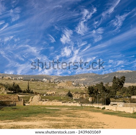 Roman ruins (against the background of a beautiful sky with clouds) in the Jordanian city of Jerash (Gerasa of Antiquity), capital and largest city of Jerash Governorate, Jordan   