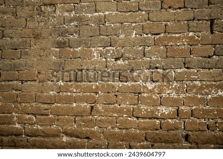 Brick wall in brown mud. Seamless texture