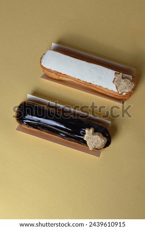 Delicious Eclairs on Golden Background, Chocolate and Vanilla Icing Eclairs with Easter Bunny Decor