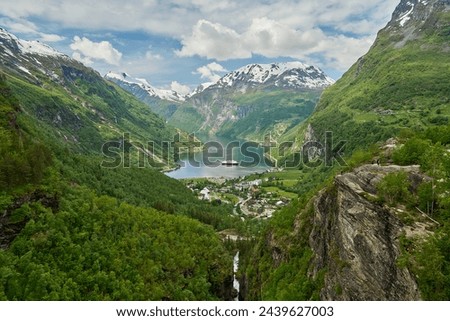 Beautiful Geiranger Fjord is a well known and popular travel destination for cruise ships and offers spectacular views to the norwegian landscape with deep gorges and snow covered mountain ranges. Royalty-Free Stock Photo #2439627003