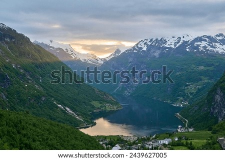 Beautiful Geiranger Fjord is a well known and popular travel destination for cruise ships and offers spectacular views to the norwegian landscape with deep gorges and snow covered mountain ranges. Royalty-Free Stock Photo #2439627005