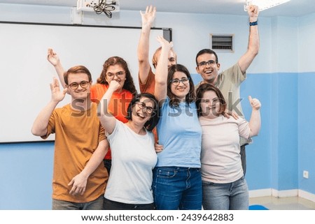 A heartwarming celebration moment with students with Down Syndrome after yoga. Royalty-Free Stock Photo #2439642883