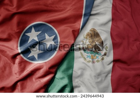 big waving realistic national colorful flag of tennessee state and national flag of mexico . macro