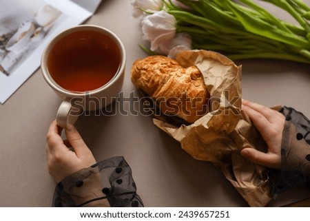 A cup of tea and a delicious croissant in your hands, good morning.