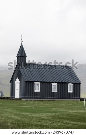 Black church of Budir at Snaefellsnes peninsula in Iceland. Travel landmarks. VErtical banner