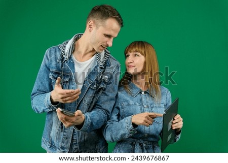 Happy young couple using digital tablet in bed. Couple shopping with tablet pc in bedroom. Man and woman use tablet computer at home. Realtime