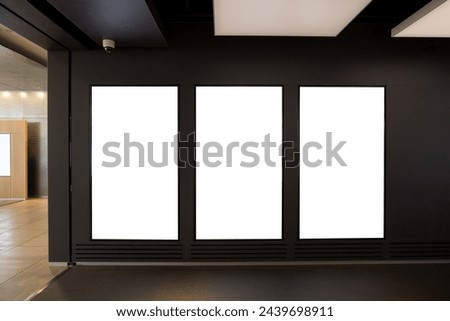Triple Vertical digital Poster Mockup background in Sleek Modern Interior. Blank white showcase screen on a wall inside an urban building. Empty 
 advertisement display media panels for promotion.