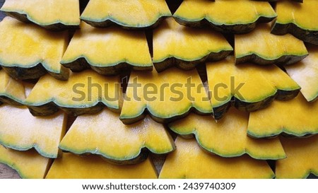 Vibrant green pumpkin slices arranged in a horizontal fish scale pattern. Wavy veins and contrasting yellow flesh. For food background wallpaper, food photography, stunning texture, Vegetable, squash