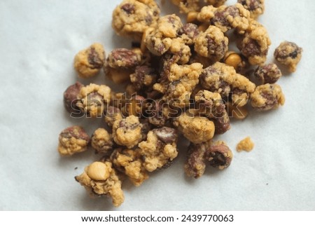 A delicious Indonesian peanut snack. Egg Nuts are nuts wrapped in wheat flour, eggs and ground spices, fried, with a curly texture, with a crunchy, crunchy and tasty taste. Royalty-Free Stock Photo #2439770063