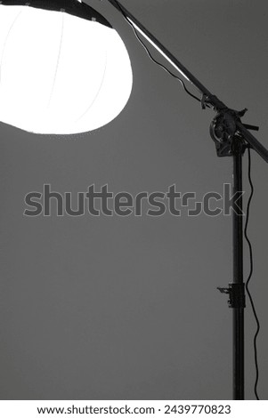 Photo Studio Light. Lantern Modifier on Crane Light Stand on Studio Cyclorama Background.  Flash Lighting Equipment. Fashion Shoot Setup. Royalty-Free Stock Photo #2439770823