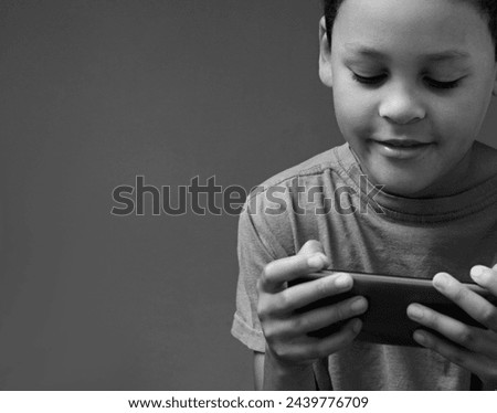 boy with mobile phone calling home on his mobile phone with grey black background with people stock image stock photo