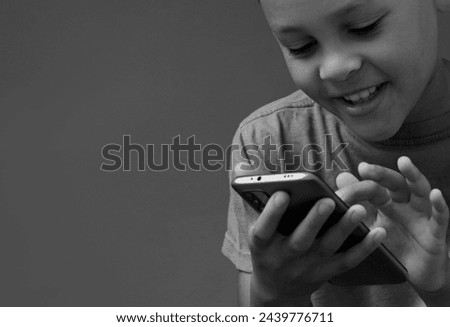 boy with mobile phone calling home on his mobile phone with grey black background with people stock image stock photo