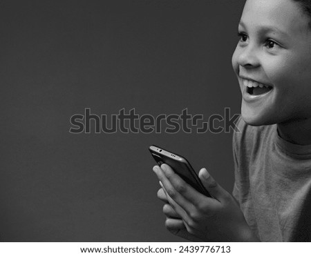 boy with mobile phone calling home on his mobile phone with grey black background with people stock image stock photo