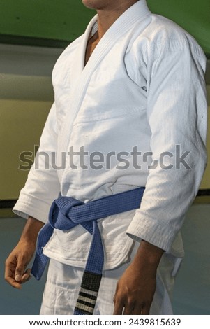 martial arts in this case jiu jitsu where you can see details of the kimono, blue belt, sweeps, grips... Royalty-Free Stock Photo #2439815639