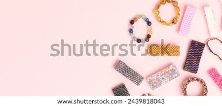 Banner with handmade beaded rings on a pink background. Place for text.
