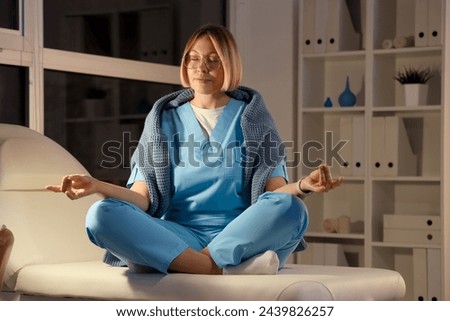 Female nurse meditating at hospital in evening
