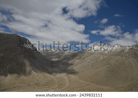 Landscape captured at Khardungla pass while traveling from Leh to Hunder town  Royalty-Free Stock Photo #2439832111