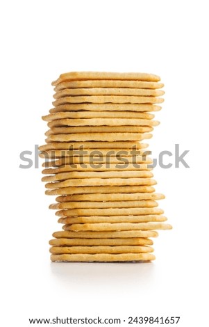 A pile of crackers stacked on a plain white surface. Isolated on white background.