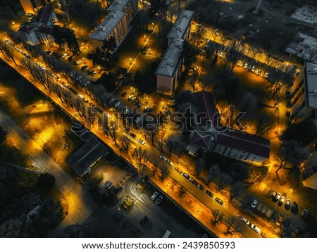Night city illuminated with lights view from a drone. Concept of urban space and city infrastructure. 