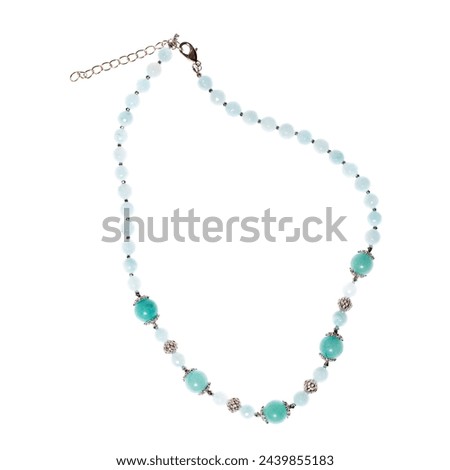 Pastel green jewelry necklace with semiprecious stones and gold chain isolated on white background