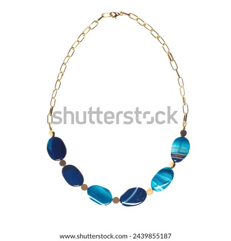 Bright blue jewelry necklace with semiprecious stones and gold chain isolated on white background Royalty-Free Stock Photo #2439855187