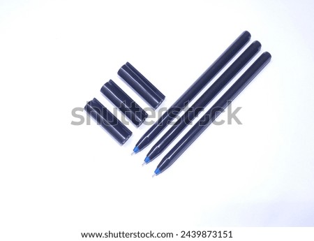 three pens with their caps orthogonally  Royalty-Free Stock Photo #2439873151
