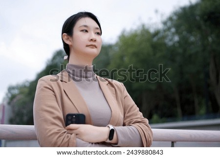 Young Female Entrepreneur Pondering in the Park